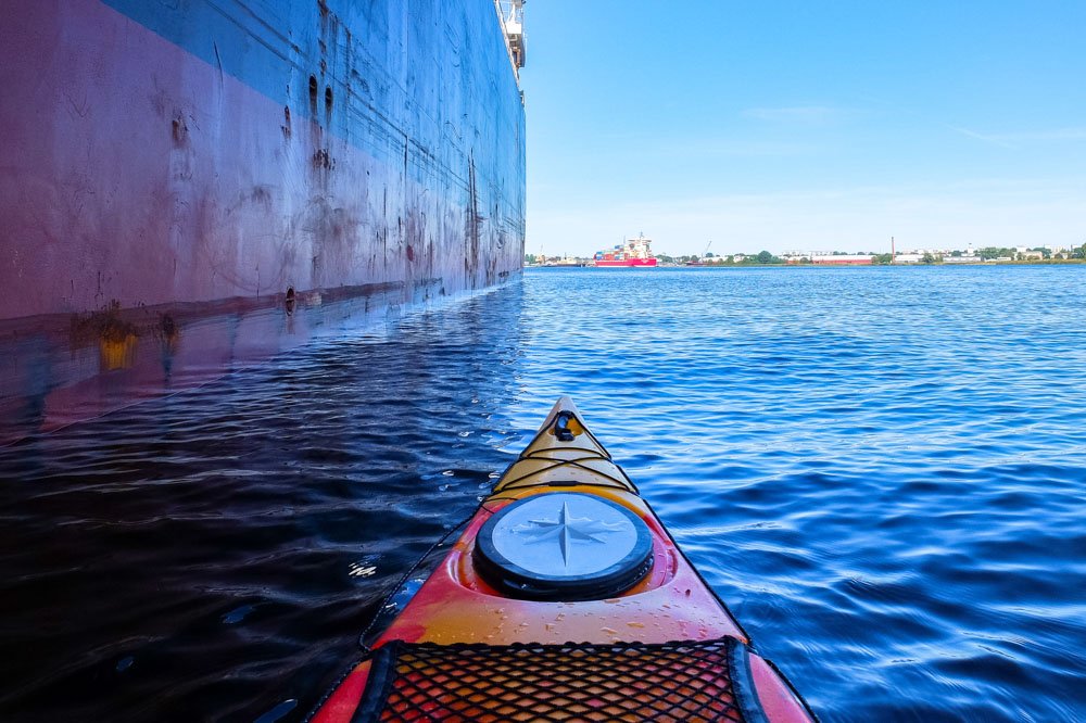 Kayak next to a big ship