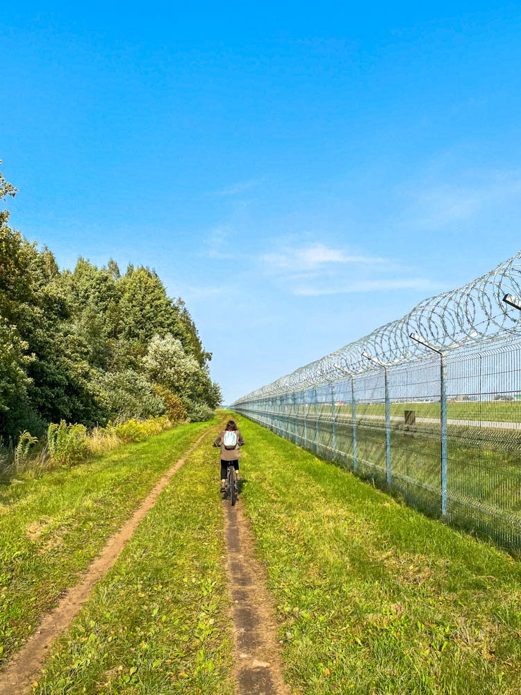 Cycling next to Riga airport fence