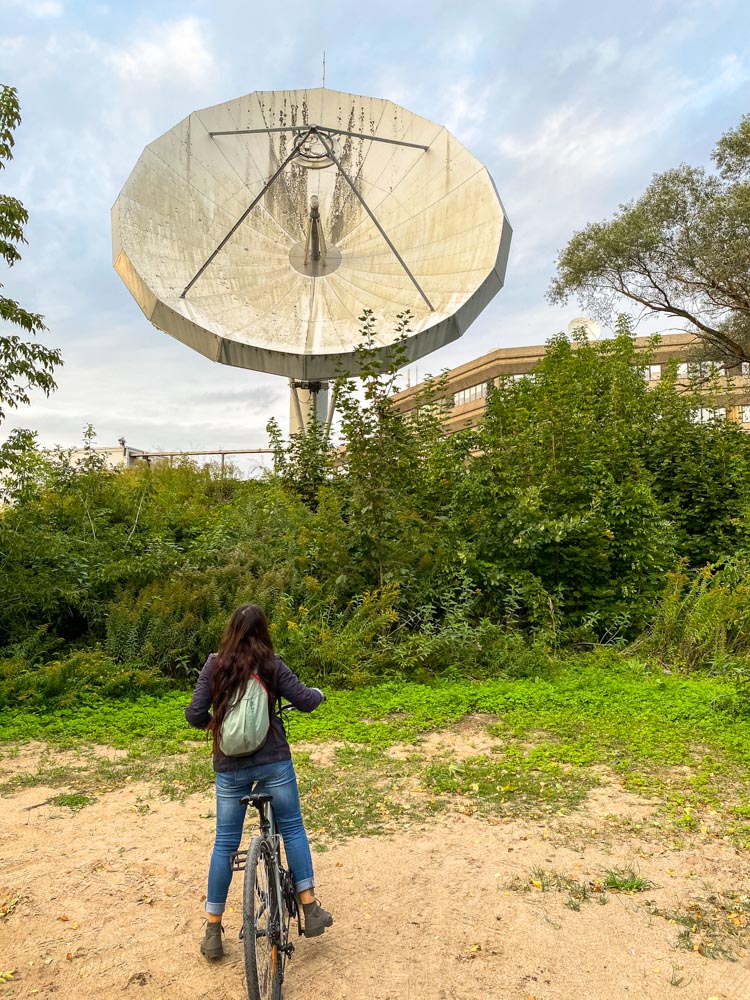 Cyclist next to a huge antenna