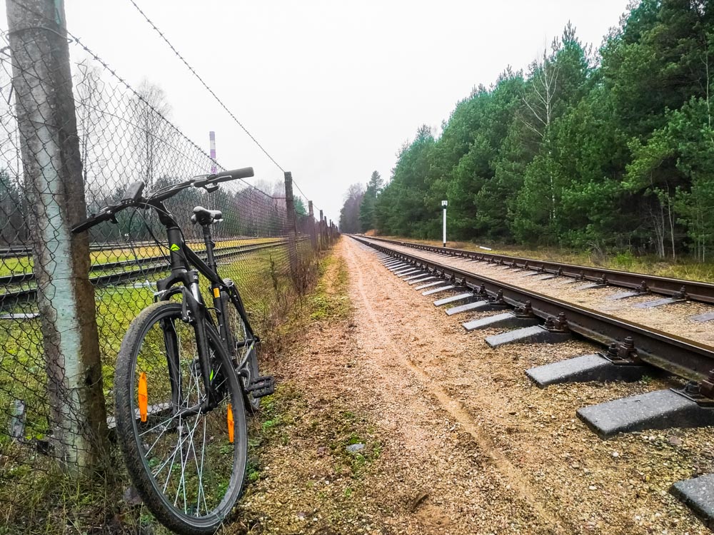Bicycle standing next to fence