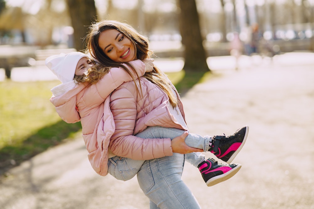Mother and child wearing pink down jackets